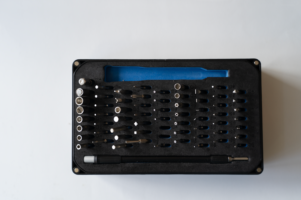 The picture is a photo showing an open toolbox with tools for electrotechnical works.